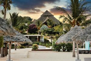 a resort with a lot of palm trees and a building at Gold Zanzibar Beach House & Spa in Kendwa