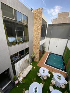 a backyard with two tables and a swimming pool at منتجع وشاليهات وسام بارك Wesam Park Residences & Chalets in Taif