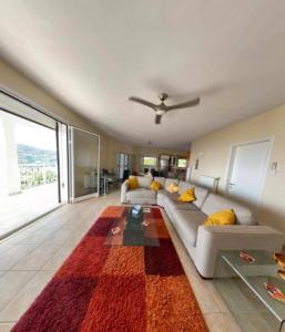 a living room with a couch and a rug at Rose Villa in Agios Stefanos