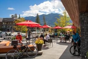 a cafe with a bike and people walking around at Banff Aspen Lodge in Banff