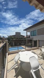 a patio with a table and chairs on a balcony at Sol e Mar - AP 05 - Be Summer in Flecheiras