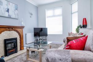 a living room with a couch and a fireplace at Hibbert Galore in Barrow in Furness