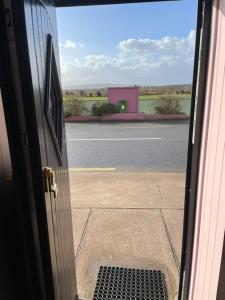a door to a building with a view of a street at Drumville House Self Catering in Castlemaine