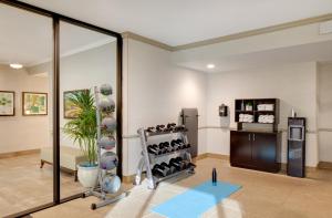 a fitness room with a rack of shoes at Ayres Hotel Corona East in Corona