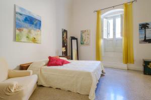 a bedroom with a bed and a couch and a window at Italianway - Morelli 3 in Lecce
