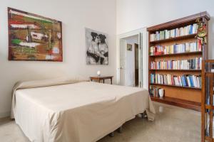 a bedroom with a bed and a book shelf with books at Italianway - Morelli 3 in Lecce