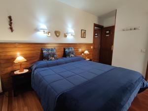a bedroom with a large blue bed in a room at Casa Rural Erletxe in Laguardia