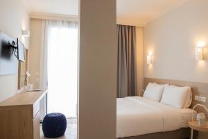 Ένα ή περισσότερα κρεβάτια σε δωμάτιο στο Zefyros Sea View Hotel