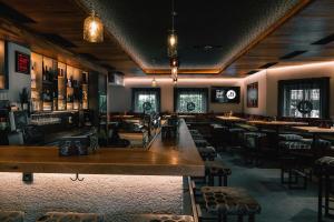a restaurant with a bar with tables and chairs at B&B Hotel Die Barbara in Schladming +53 photos
