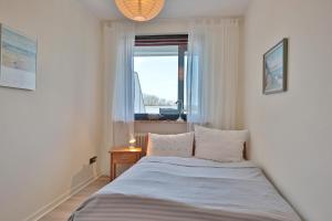 a small bedroom with a bed with a window at Appartementanlage am Taschensee Taschensee Appartement 9 in Gronenberg