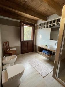 bagno con 2 servizi igienici e lavandino di S'Abba Druche rooms a Bosa