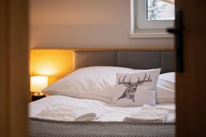 En eller flere senge i et værelse på Osada Wróblonki - Apartamenty