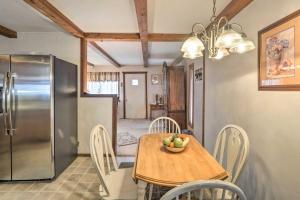 a kitchen with a table and a stainless steel refrigerator at The Lakehouse Lovely Wappapello Country Home! in Wappapello +26 photos