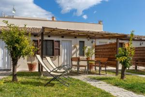 uma casa com uma mesa e cadeiras no quintal em Agriturismo Case Don Ignazio em Casale Modica