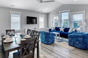 a living room with a table and a blue couch at Prickly Pear 723 in Avon