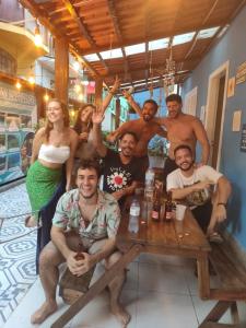 a group of people posing for a picture at a table at Hostel e Pousada Blue Lagoon in Abraão +27 photos