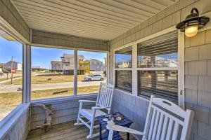 two chairs on a porch with a view of a street at Nags Head Cottage Screened Porch, Walk to Beach! in Nags Head