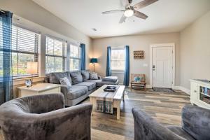 a living room with a couch and a table at Mexico Beach Getaway with Patio - Steps to Beach! in Mexico Beach