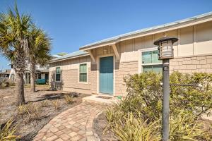 a house with a street light in front of it at Mexico Beach Getaway with Patio - Steps to Beach! in Mexico Beach