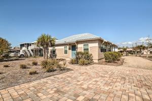 a house with a brick driveway in front of it at Mexico Beach Getaway with Patio - Steps to Beach! in Mexico Beach