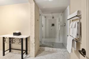 a bathroom with a walk in shower and a walk in shower at The Francis Hotel in Portland