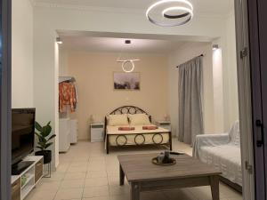 ein Wohnzimmer mit einem Bett und einem Tisch in der Unterkunft ''Korifo apartment'' at Benitses in Benitses