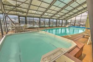 a large indoor swimming pool with a view of a city at Dillon Inn in Dillon