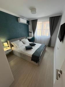 a bedroom with a large bed with blue walls at Luxury Private Apartment near Green Life Resort in Sozopol