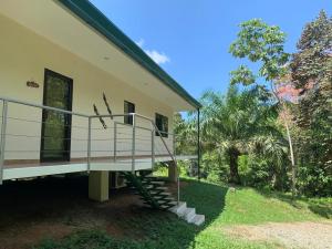 a house with a staircase leading to the front of it at Villa Iguana - Great place & privacy with Jacuzzi & WiFi in Quepos