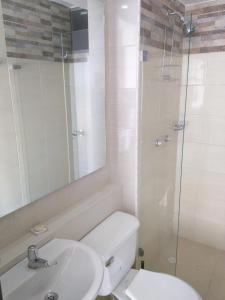 a bathroom with a toilet and a sink and a shower at Apartamento en Ricaurte in Ricaurte