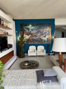 a living room with a painting on the wall at Villa Olimpia in Mondello