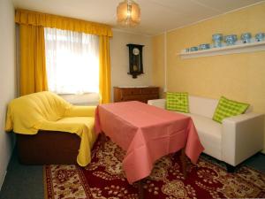 a living room with a table and chairs and a window at Bungalow garden idyll, Berlin in Berlin