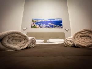 a bedroom with a bed with towels on it at CASA MARTINO FORMALE in Naples