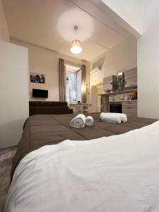 a bedroom with a large bed with two towels on it at CASA MARTINO FORMALE in Naples