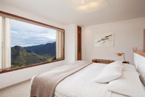 a bedroom with a bed and a large window at El Crater in San Antonio