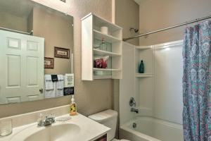 a bathroom with a sink and a toilet and a mirror at San Antonio Abode Near Golf, Shops and Dining! in San Antonio +19 photos