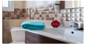 a bathroom with a sink with a blue towel on it at Apartamento en Olvera in Olvera