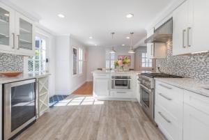 a kitchen with white cabinets and white counter tops at 45A Pleasant St in Nantucket