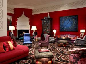 a living room with red walls and a fireplace at The Royal Sonesta Portland Downtown in Portland