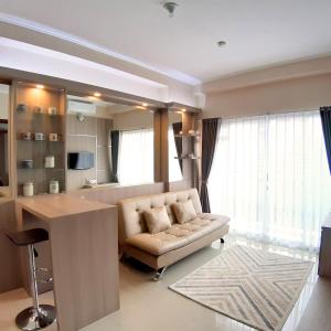 sala de estar con sofá y mesa en High Livin Apartment Pasteur en Bandung