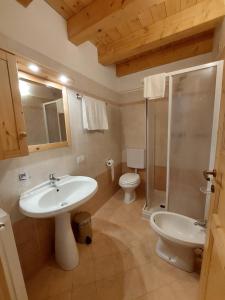 a bathroom with a sink and a toilet and a shower at Rifugio Fornas in Tolmezzo +78 photos