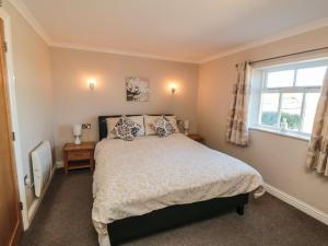 a bedroom with a bed and a window at Blakey in Liverton