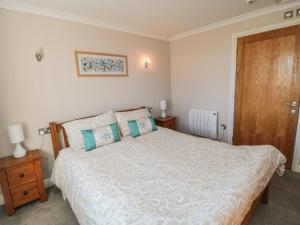 a bedroom with a large bed and a wooden door at Freeborough in Liverton