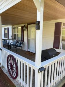 a front porch of a house with a wagon on it at Home in the Heart of W.V. Adventure Country! in Mount Hope