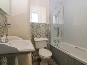 a bathroom with a toilet and a sink and a shower at The West Wing in Skye of Curr +19 photos