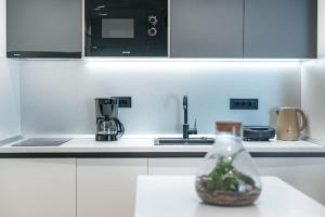 a kitchen with a counter top with a bottle on the counter at Apartment Old Town Finesse in Dubrovnik +21 photos