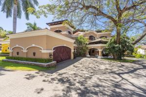 a large house with a driveway in front of it at Extravagant Beachfront Mansion in Flamingo, Second to None in Playa Flamingo