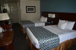 a hotel room with two beds and a desk at Rodeway Inn Kanab - National Park Area in Kanab