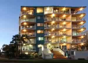a tall apartment building with lights on it at Waterview Resort in Caloundra