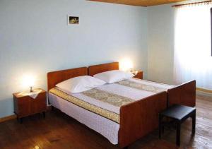 a bedroom with a large bed with a wooden headboard at House Viskic in Supetarska Draga